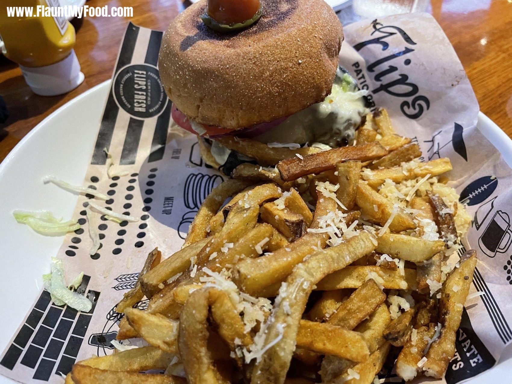 Flips Mushroom Swiss BurgerFlips in Fort Worth was a fun atmosphere with delicious foods. This is a mushroom swiss burger I added blue cheese to as well. The fries have parmesan cheese and minced garlic sprinkled on.