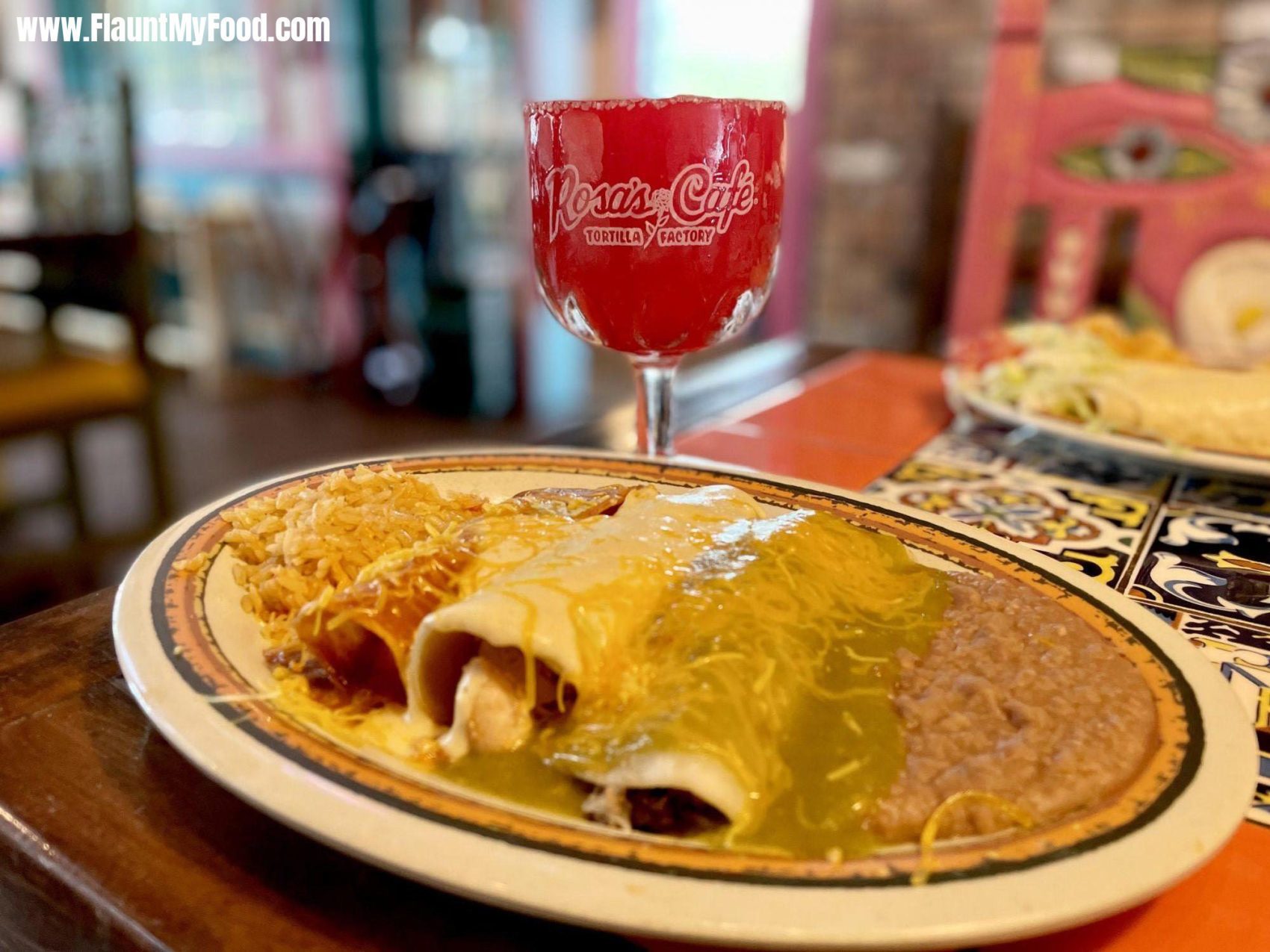 Three enchilada plate at rosas café tortilla factory in Fort WorthEnchilada plate with beans rice and cheese with a strawberry margarita at Rosa‘s Café in Southwest Fort Worth Texas