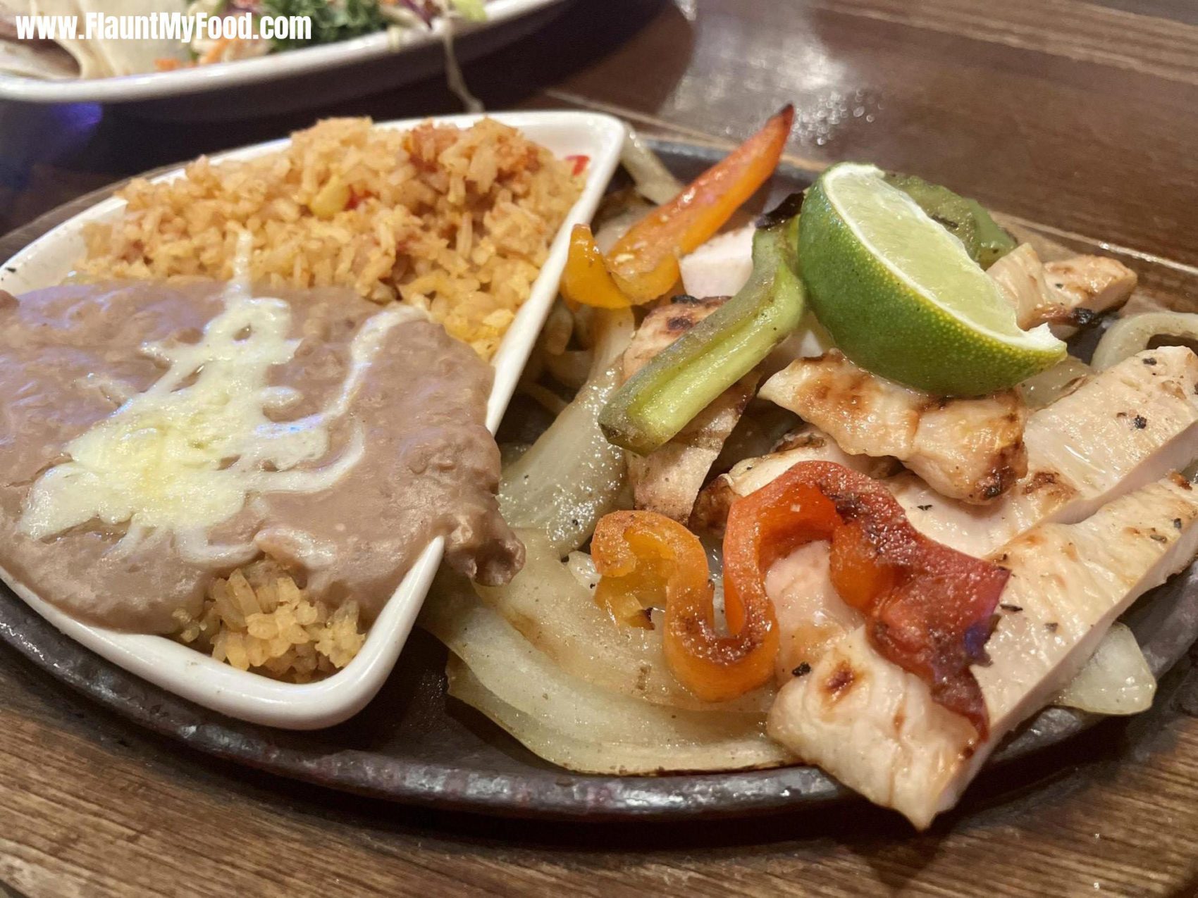 Mexican Inn on Hulen Street Fort Worth TexasChicken fajitas with beans and rice and freshly cut vegetables peppers and onions located on South Hulen in Fort Worth Texas great Mexican food.