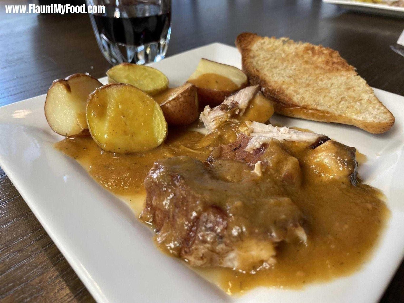 Braised Pork LoinBraised pork loin covered in gravy made from its cooking juices, including Chronic Cellars red blend wine, and vegetables. Side of roasted potatoes and buttered toast..