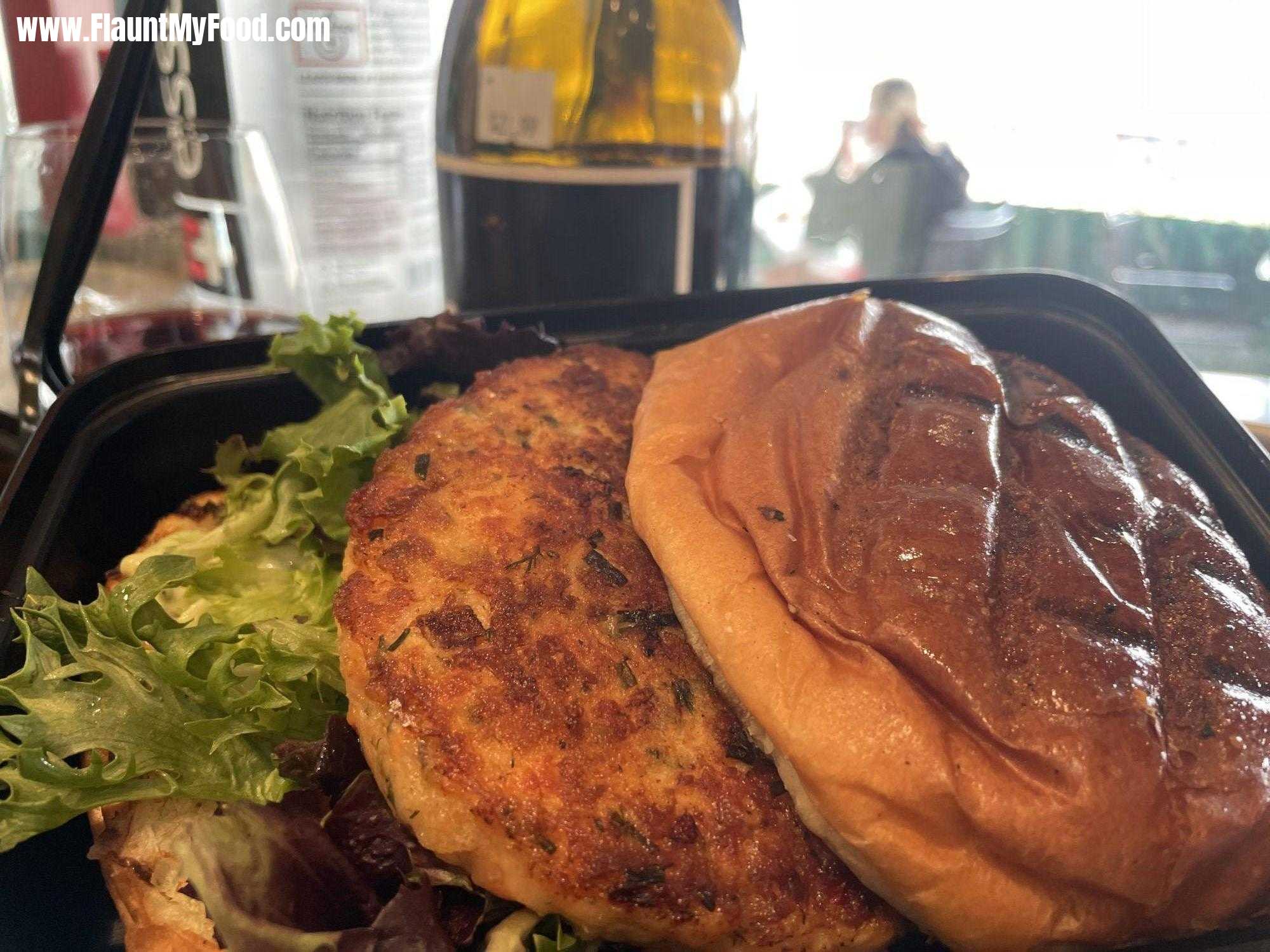 Salmon hamburger with fries at EatZi‘s market and bakery in Fort Worth Texas off of University Drive