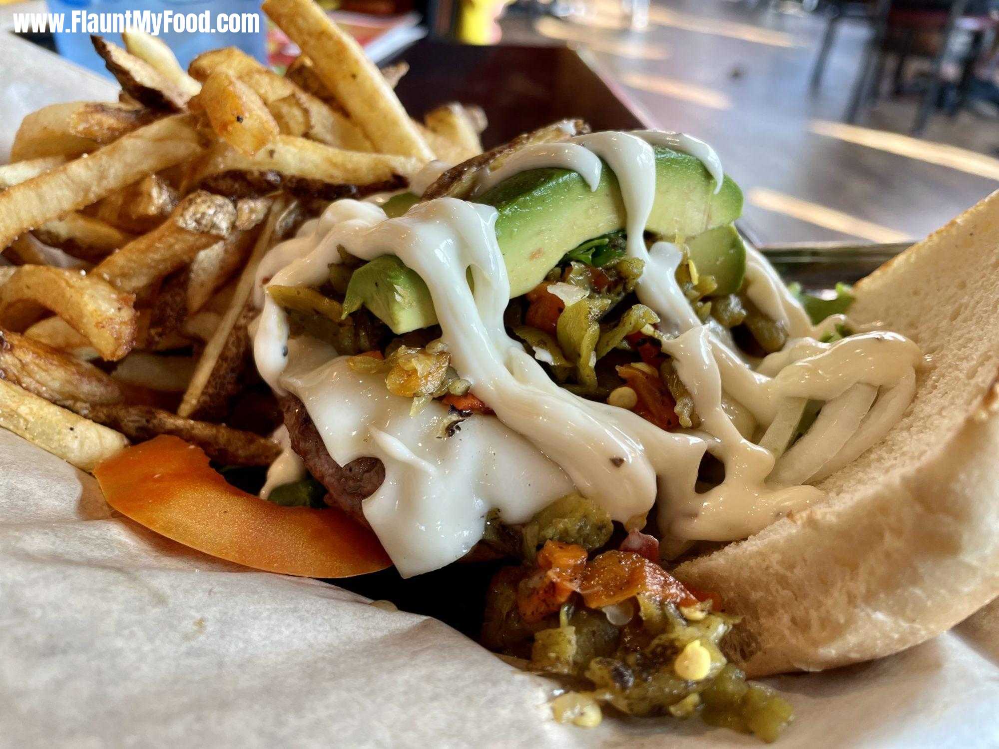 Border Burger Bar, Manitou Springs ColoradoCapture the essence of the Southwest and share your love for food with our Coloradoan Hatch Green Chile Burger. This mouth-watering creation features a juicy roasted green chile beef patty, Swiss cheese, fresh avocado, diced hatch green chile, spring mix, tomato, onion slices, and a tangy lemon zest aioli. Snap a pic of this delectable burger and share it on FlauntMyFood.com, where food lovers come together to celebrate the beauty of cuisine. Show off your culinary prowess and make mouths water with every post. Join our community today!