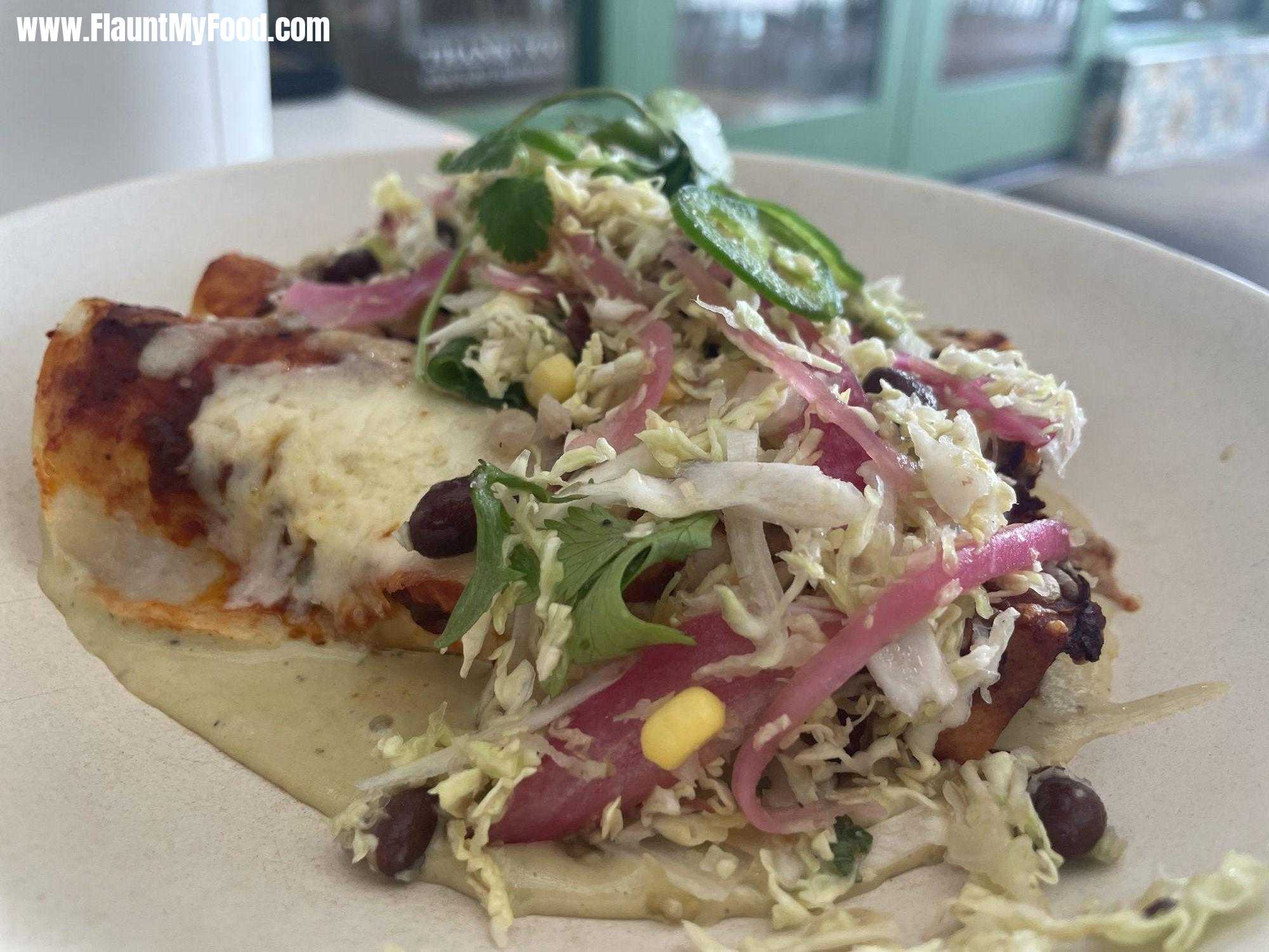 Chicken Enchiladas at Flower Child Restaurant in Fort Worth TexasI recently visited Flower Child near TCU in Fort Worth Texas. The restaurant is quaint and touts healthy eating. Flower Child's restaurant seems to appeal to a variety of demographics, but I did notice quite a few TCU students in there when I went. The bottle neck of the restaurant is the ordering process. So if there are a few people in front of you, it takes a while to order. Not ideal if you order your food and then sit down and realize you want a glass of Pinot Noir wine. Overall a nice visit, but very open so not to private.