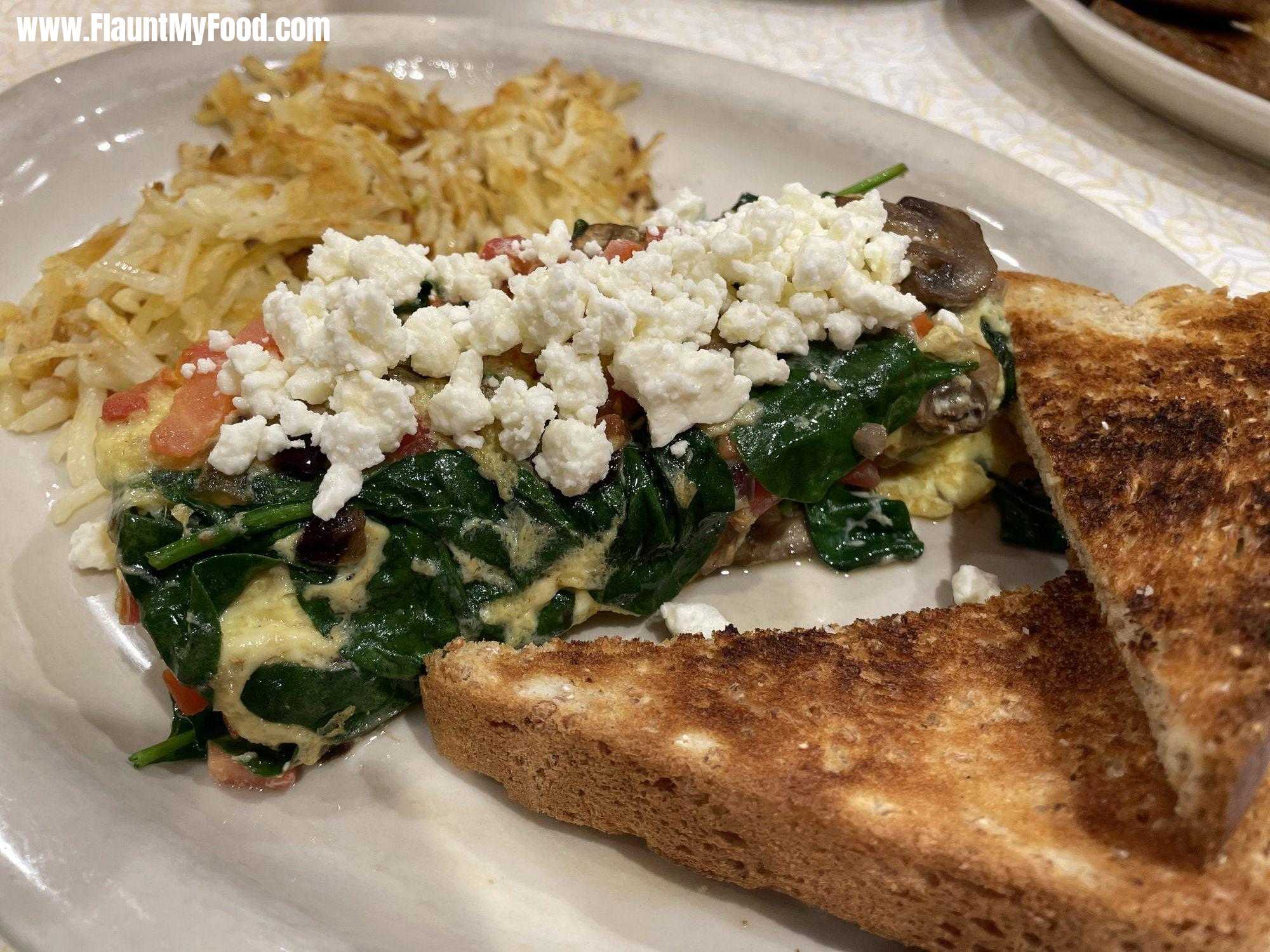 Feta, spinach, mushroom omeletteWheat toast with a feta omelette, including tomatoes, spinach, feta mushrooms, and hashbrowns on the side with coffee at Parris off of Montgomery Street in Fort Worth Texas
