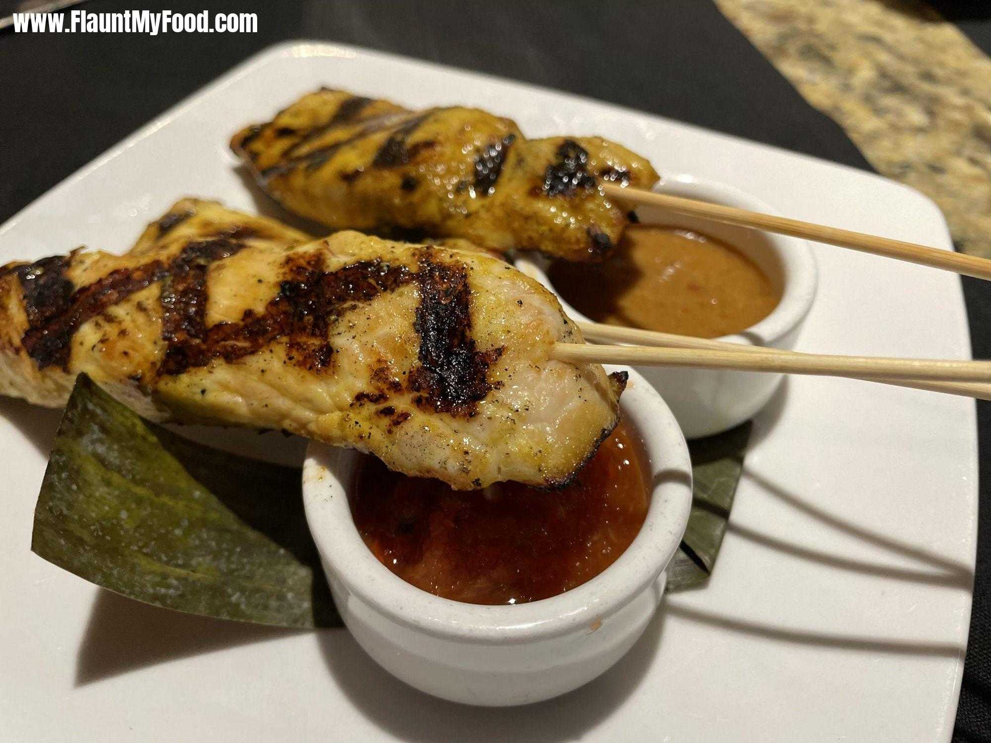 Grilled Chicken SatayMalai Kitchen in Clearfork, Fort Worth, Texas. Grilled chicken, satay marinated in paste of garlic, coconut milk, turmeric, red Boat, five piece and soy served with peanut sauce and chili shallot relish.