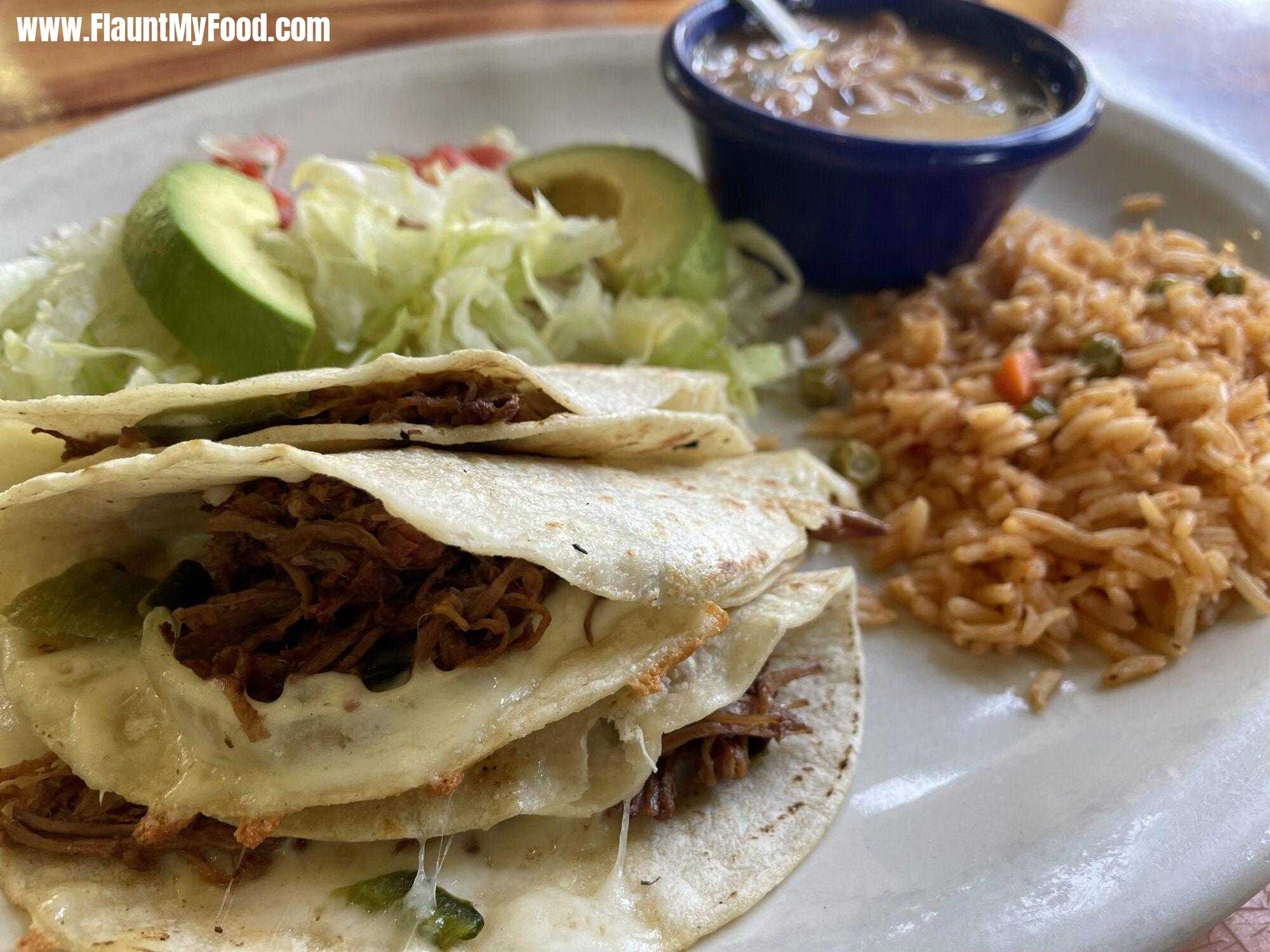 Brisket. Tacos with rice and avocado and beans with green salsa on the side at Esparza‘s in a grapevine, Texas.